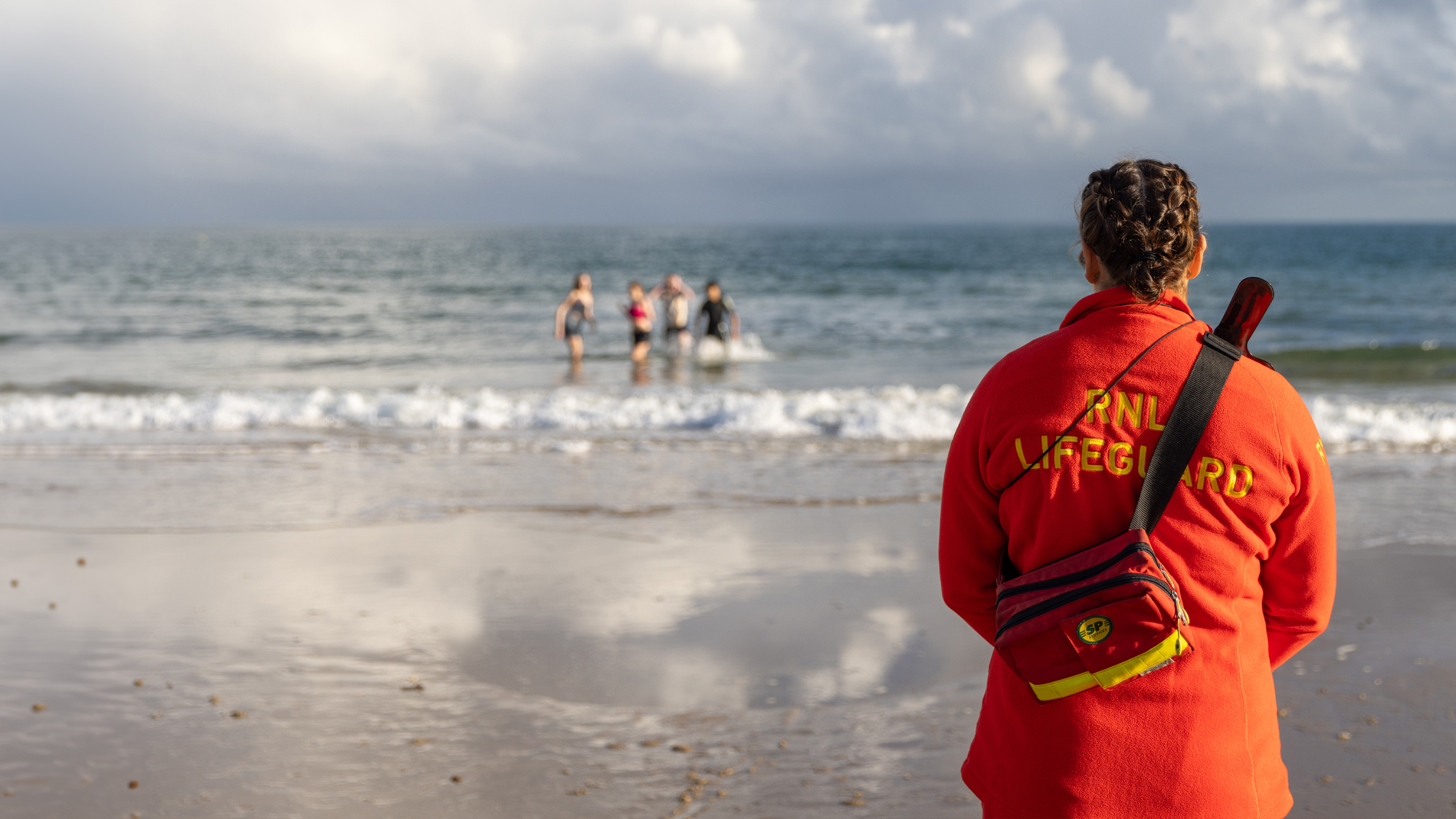 RNLI Lifeguard Tegan Bird looking out to sea.